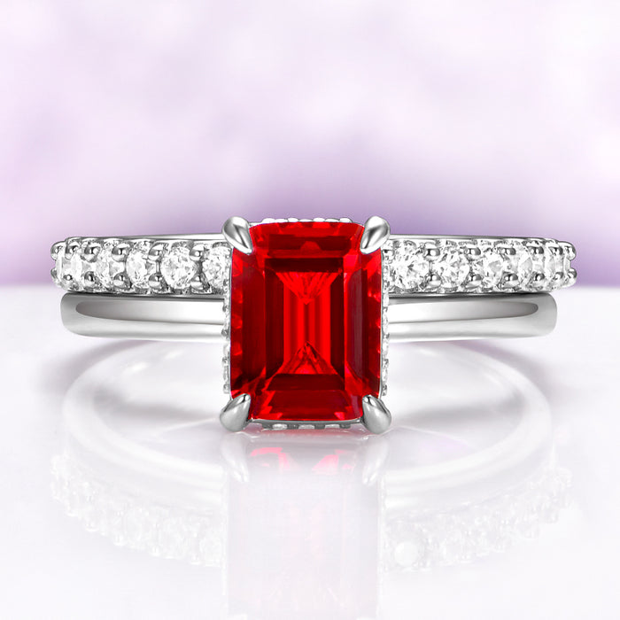 Raspberry Tourmaline Solitaire Engagement Ring in Sterling Silver by Aquamarise, featuring an emerald-cut red gemstone with diamond accents on a polished band, perfect for October birthstone jewelry.