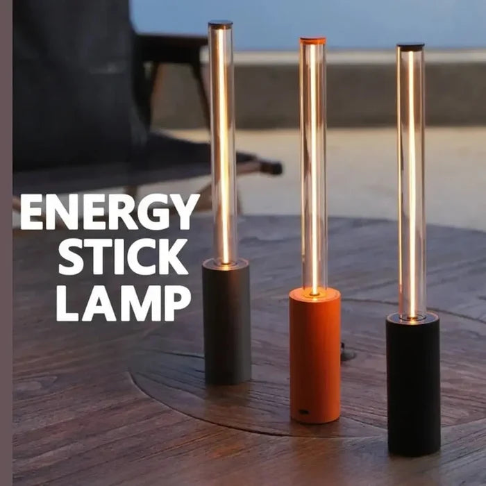 Rechargeable LED night light in a set of three stylish energy stick lamps on a wooden table.