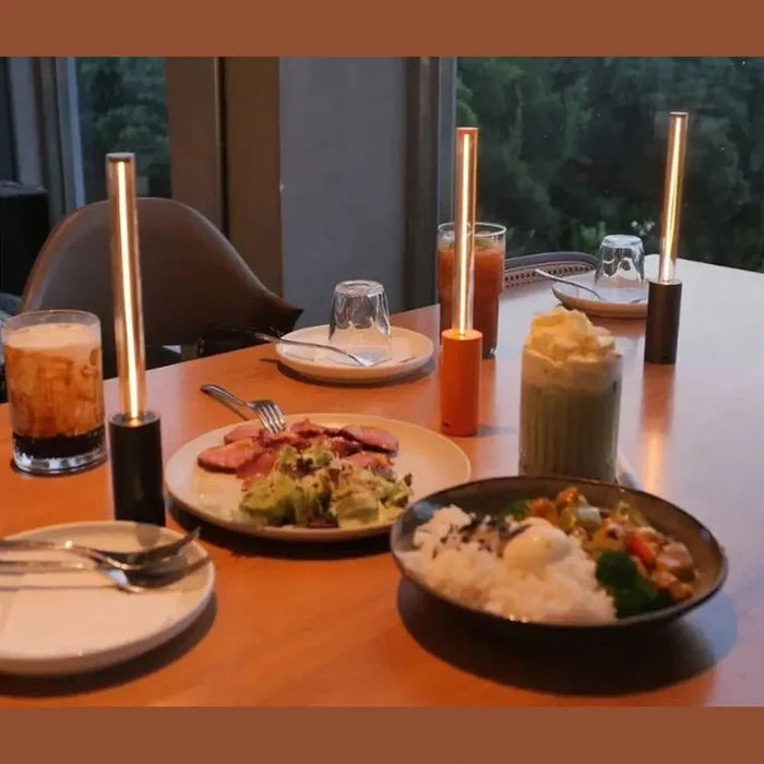 Rechargeable LED night light illuminating a dining table with food and drinks, creating a cozy atmosphere.
