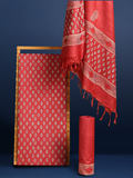 Bright red katan silk unstitched suit set hand block printed with small angular teal and off-white sprigs and geometric bands at the ends of the length.