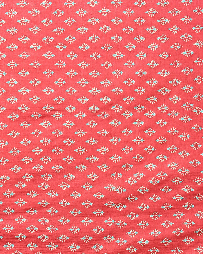 Bright red katan silk unstitched suit set hand block printed with small angular teal and off-white sprigs and geometric bands at the ends of the length.