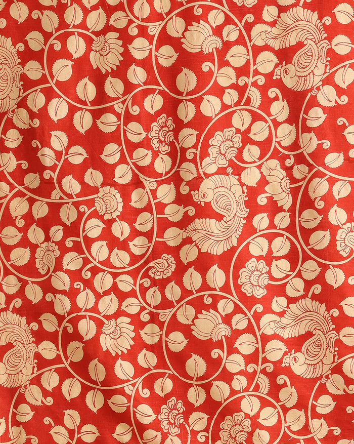 Red Katan silk unstitched suit set hand block printed with cream peacocks and floral vines in an all-over repeat, with a fringed dupatta and a horizontal patterned band on the bottom piece.