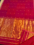 Magenta-red Maheshwari silk saree with small zari buta and a wide golden yellow zari border, handwoven in Maheshwar