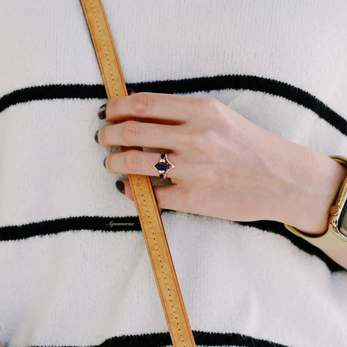 Galaxy Sandstone Starry Night Couples Ring Set by Aquamarise featuring a rose gold band with deep blue sandstone and diamond accents, styled on a hand with natural lighting and a striped sweater.