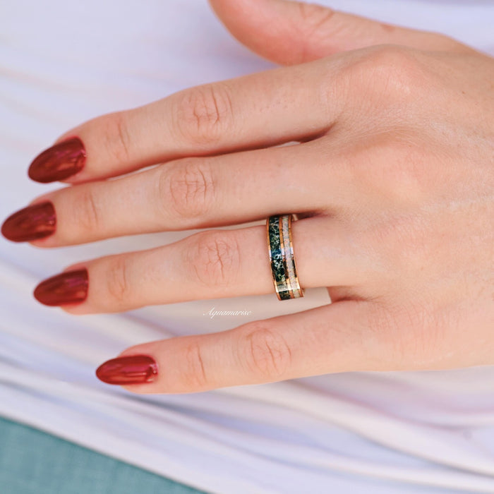 Moss Agate & Fire Opal Couples Ring Set by Aquamarise, featuring green moss agate and iridescent fire opal inlays on rose gold bands, styled on hand with red nails, part of Matching Couples' Rings.