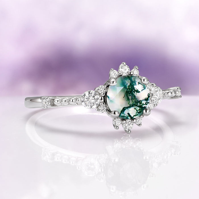 Round Green Moss Agate Ring in Sterling Silver by Aquamarise featuring a round green moss agate center with sparkling diamond accents on a polished detailed silver band.