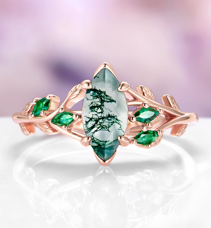 Moss Agate, Peacock Opal & Whiskey Barrel Wood Couples Ring Set featuring a marquise moss agate centerpiece with delicate green accents on a rose gold band, crafted by Aquamarise in a nature-inspired, matching design.