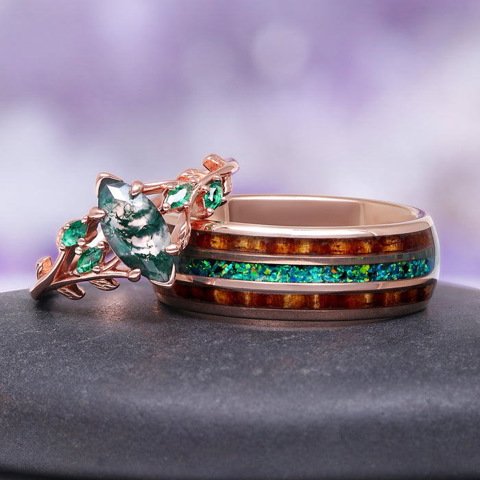 moss agate leaf engagement ring with wood inlay tungsten band on gray surface against purple background