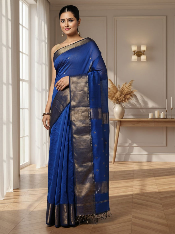 Royal blue Maheshwari silk saree with small gold buti across the body and a wide gold zari border, handwoven in Maheshwar
