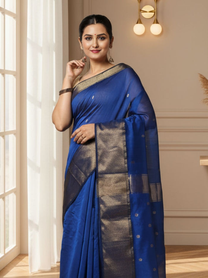 Royal blue Maheshwari silk saree with small gold buti across the body and a wide gold zari border, handwoven in Maheshwar