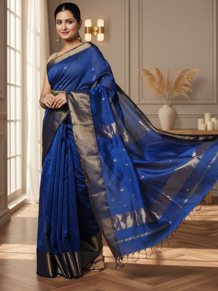 Royal blue Maheshwari silk saree with small gold buti across the body and a wide gold zari border, handwoven in Maheshwar