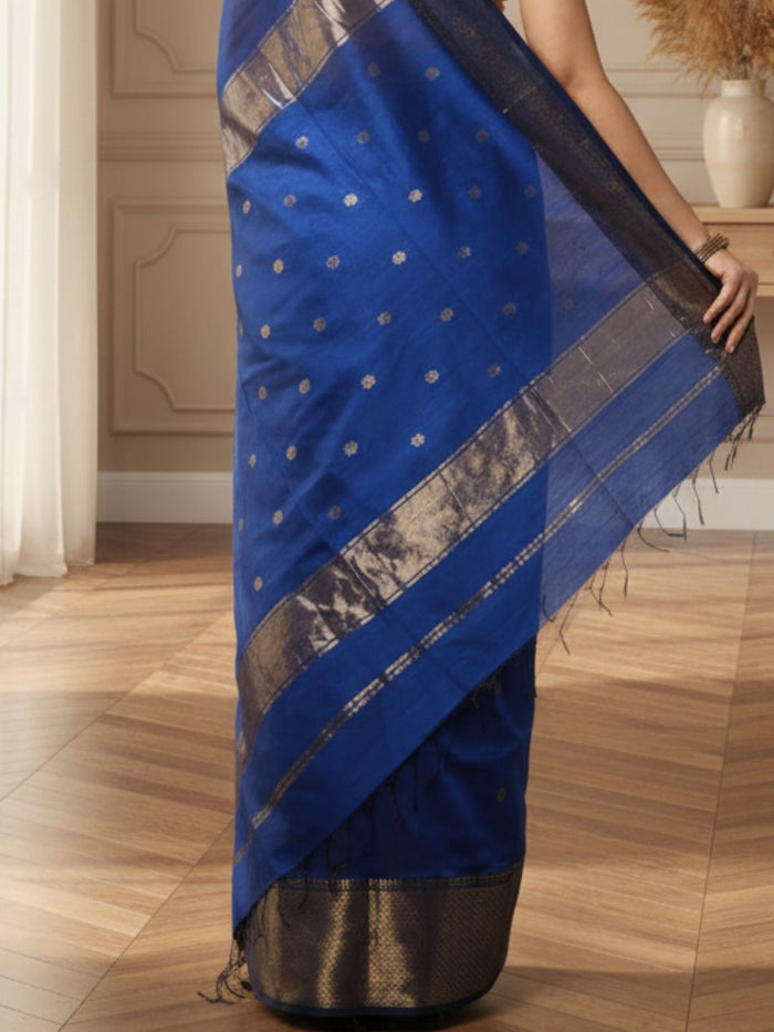 Royal blue Maheshwari silk saree with small gold buti across the body and a wide gold zari border, handwoven in Maheshwar