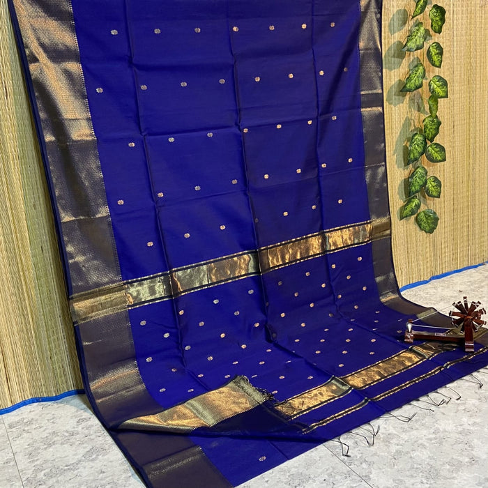 Royal blue Maheshwari silk saree with small gold buti across the body and a wide gold zari border, handwoven in Maheshwar