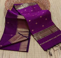 Royal purple Maheshwari silk saree with small gold buti and a wide, densely patterned gold geometric border, handwoven in Maheshwar