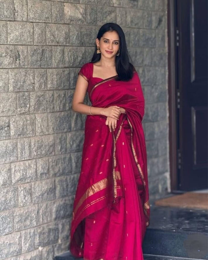 Ruby red Maheshwari silk saree with all-over buta body and parallel gold zari bands along the borders, handwoven in Maheshwar