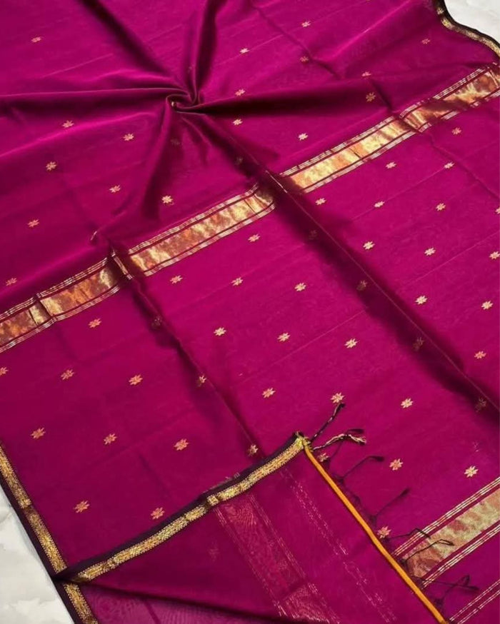 Ruby red Maheshwari silk saree with all-over buta body and parallel gold zari bands along the borders, handwoven in Maheshwar