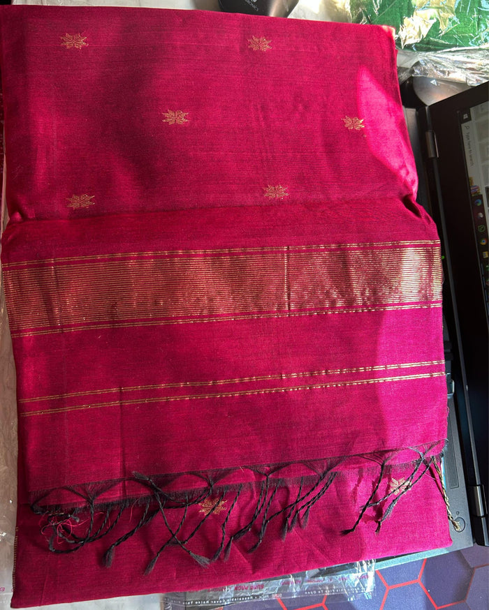 Ruby red Maheshwari silk saree with all-over buta body and parallel gold zari bands along the borders, handwoven in Maheshwar