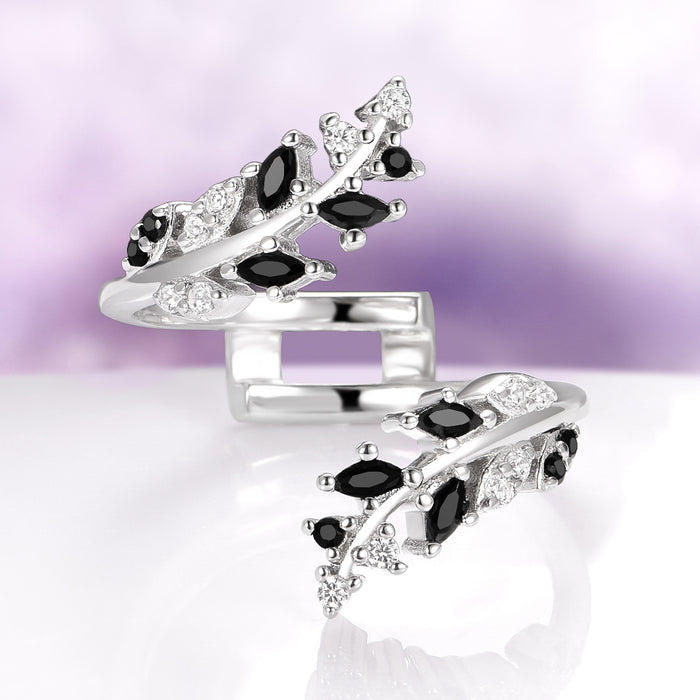Black Moissanite Leaf Ring Guard in 14K White Gold by Aquamarise Gold, featuring delicate leaf and vine motifs adorned with marquise and round black moissanite stones and sparkling white accents, part of Solid Gold Engagement Rings and Lovers of the Dark™ collections.