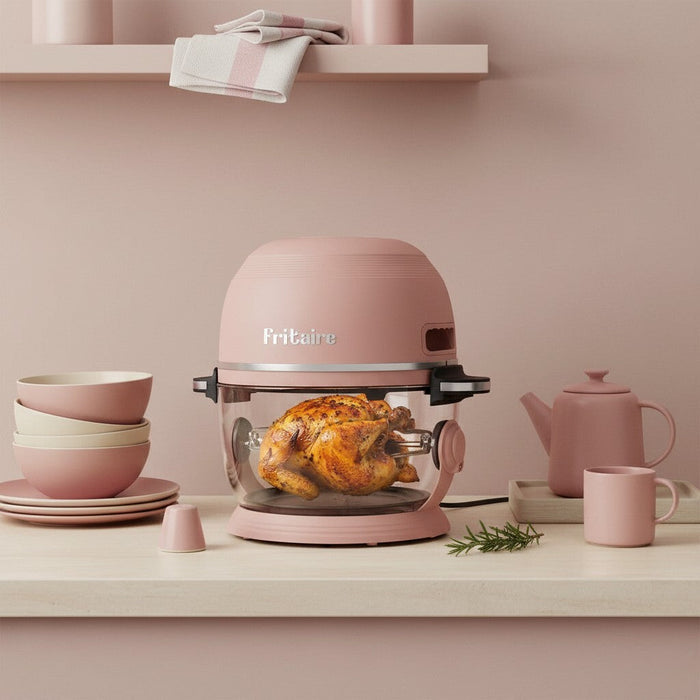 Self-cleaning air fryer in mauve rose with a perfectly roasted chicken, showcasing kitchen elegance and functionality.