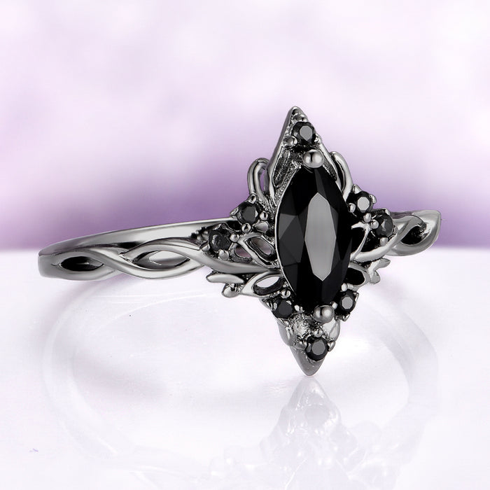Silver ring with a black gemstone on a white background