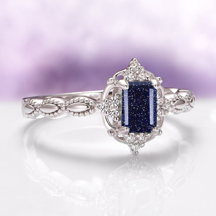 Starry Night (Sandstone) Engagement Ring in 14K White Gold featuring an emerald-cut Galaxy Sandstone with sparkling accents on a vintage-inspired detailed band by Aquamarise Gold.
