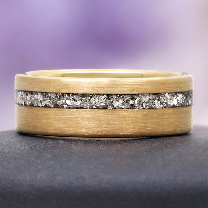Crushed Diamond Gold Tungsten Ring (8mm) by Aquamarise, featuring a brushed yellow-gold band with an off-center channel of raw silver-white crushed diamond crystals.