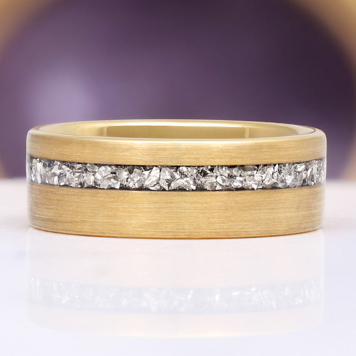 Crushed Diamond Gold Tungsten Ring (8mm) by Aquamarise, featuring an 8mm brushed yellow-gold band with an off-center raw silver-white crushed diamond crystal inlay.