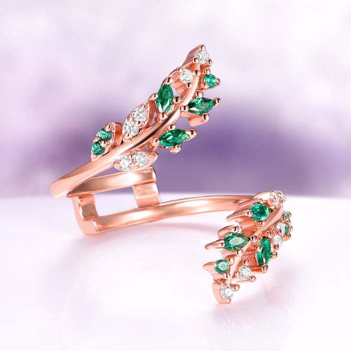 Lab-Grown Diamond & Emerald Leaf Engagement Ring Set in 14K Solid Rose Gold (IGI Certified) featuring delicate marquise-cut emeralds and sparkling lab-grown diamonds arranged in an intricate leaf design by Aquamarise Gold, part of their nature-inspired and birthstone collections.