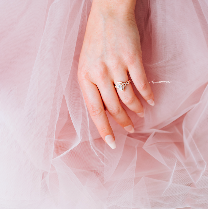 Nouveau Diamond (cz) Engagement Ring Set- 14K Rose Gold Vermeil on hand with soft pink tulle background, featuring elegant twisted vine band by Aquamarise.