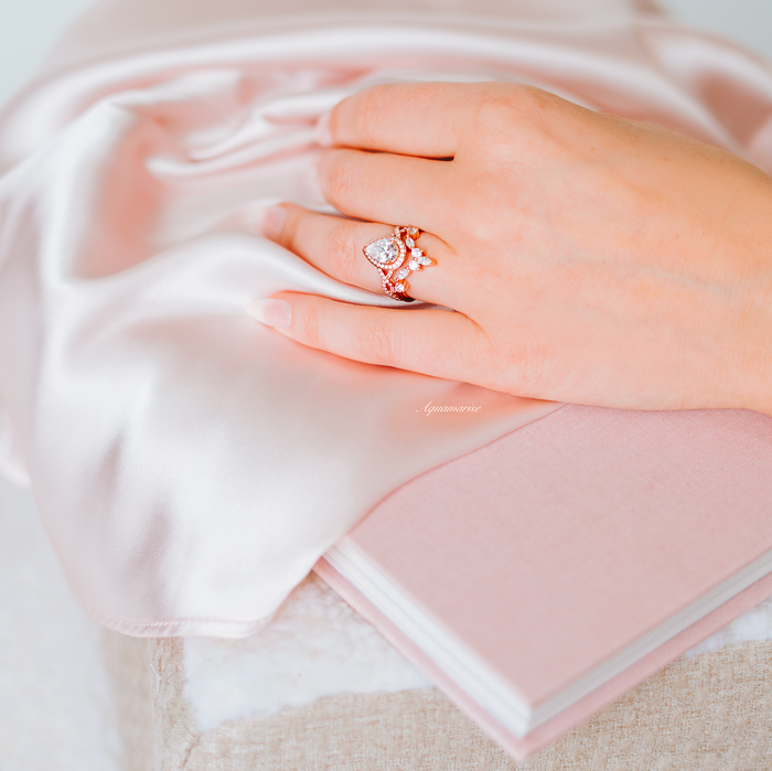 Nouveau Diamond (cz) Engagement Ring Set- 14K Rose Gold Vermeil on hand, featuring a pear-shaped center stone and scalloped pavé design by Aquamarise.
