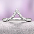 Skye Kite® Chevron Stacking Wedding Band in 14K White Gold by Aquamarise Gold features a delicate V-shaped design adorned with petite moissanite stones, part of the Women’s Wedding Bands and Solid Gold Rings collections.