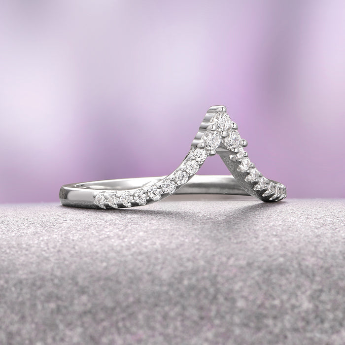 Skye Kite® Chevron Stacking Wedding Band in 14K White Gold by Aquamarise Gold features a delicate V-shaped design adorned with petite moissanite stones, part of Women’s Wedding Bands and Skye Kite® Jewelry Collection.