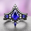 Skye Kite® Cornflower Sapphire Ring Set- Black Ruthenium displays a striking kite-cut cornflower blue sapphire centerpiece accented by marquise and round white gemstones on a black ruthenium over sterling silver band, crafted by Aquamarise and featured in September Birthstone Jewelry, Fantasy-Inspired Engagement Rings, and Lovers of the Dark™ collections.