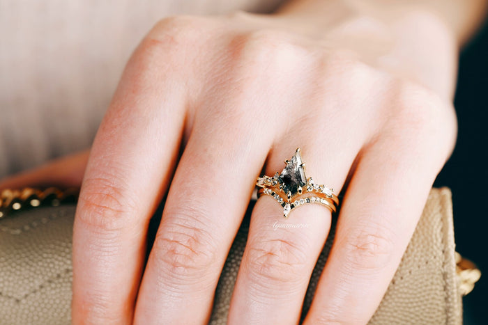 Skye Kite® Galaxy Herkimer Diamond & Meteorite Couples Ring Set by Aquamarise, featuring a black meteorite and Herkimer diamond ring on a hand holding a beige textured purse.