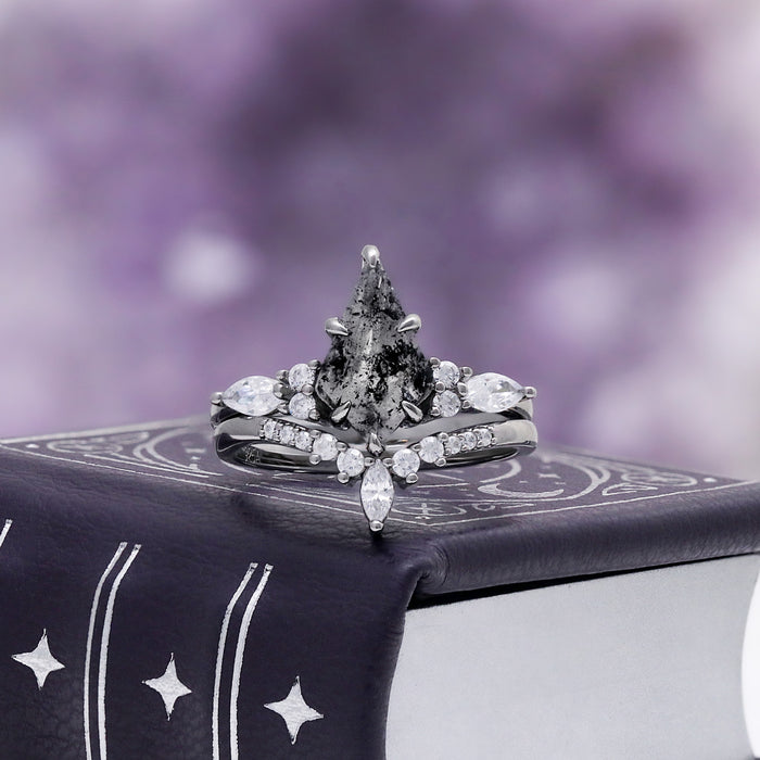 Skye Kite Galaxy Herkimer Diamond Ring Set in Black Ruthenium by Aquamarise, a kite-cut salt and pepper Herkimer diamond on a celestial-print backdrop.