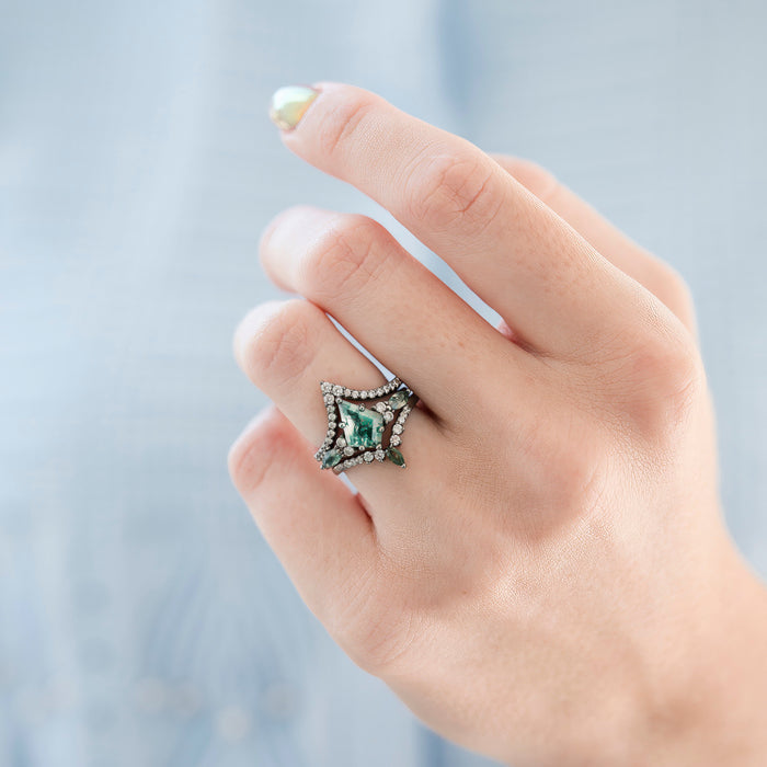 Skye Kite® Green Moss Agate Engagement Ring Set in Black Ruthenium (3-piece) shown on a hand, featuring a distinctive kite-cut green moss agate stone surrounded by black ruthenium and sparkling accents, by Aquamarise.