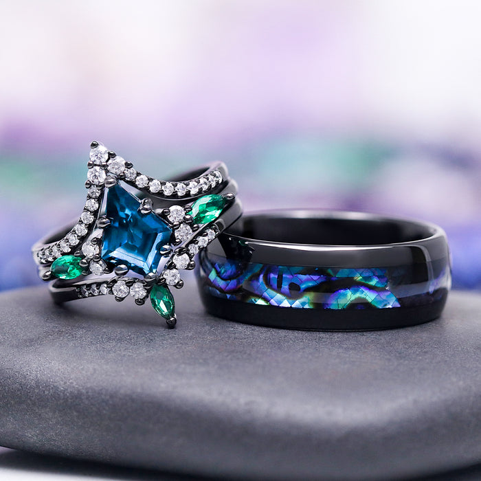 Two rings, one with a star-shaped blue gem and the other with a black band and colorful inlay, on a gray surface with a blurred multicolored background.