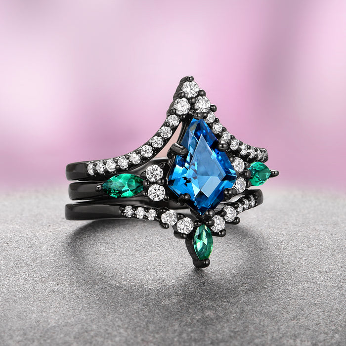 Skye Kite® London Blue Topaz & Emerald Ring Set- Black Ruthenium showcasing a kite-cut blue topaz with emerald accents and white stones on black ruthenium by Aquamarise.