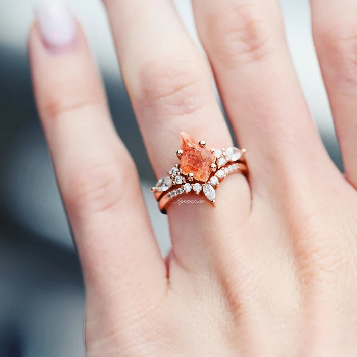 Skye Kite® Natural Sunstone Ring Set in 14K Rose Gold Vermeil by Aquamarise, featuring a raw kite-cut sunstone with marquise and round white stone accents on a hand.