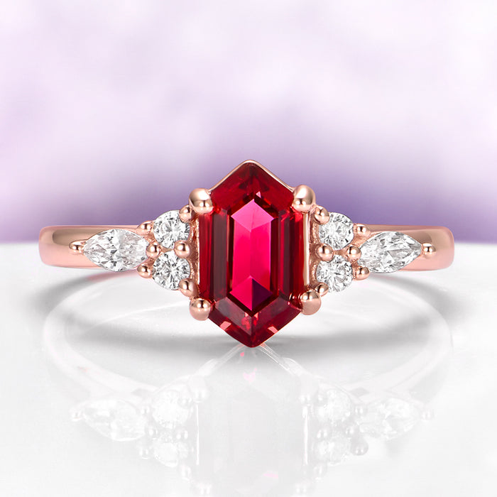 Sonnet Hexagon Ruby Engagement Ring in 14K Rose Gold Vermeil featuring a hexagon ruby center stone flanked by marquise and round white stones on a polished rose gold band by Aquamarise.