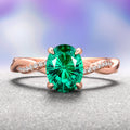Sophia Fireworks Cut Emerald Engagement Ring in 14K Solid Rose Gold by Aquamarise Gold features a vibrant fireworks-cut emerald centerpiece with a twisted band accented by sparkling diamonds, part of Solid Gold Engagement Rings and May Birthstone Jewelry collections.