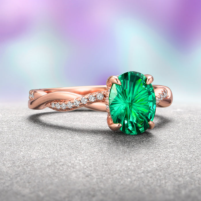 Sophia Fireworks Cut Emerald Engagement Ring in 14K Solid Rose Gold by Aquamarise Gold showcases a vibrant green fireworks-cut emerald set on a twisted rose gold band adorned with dazzling diamond accents, part of the Solid Gold Engagement Rings and May Birthstone Jewelry collections.