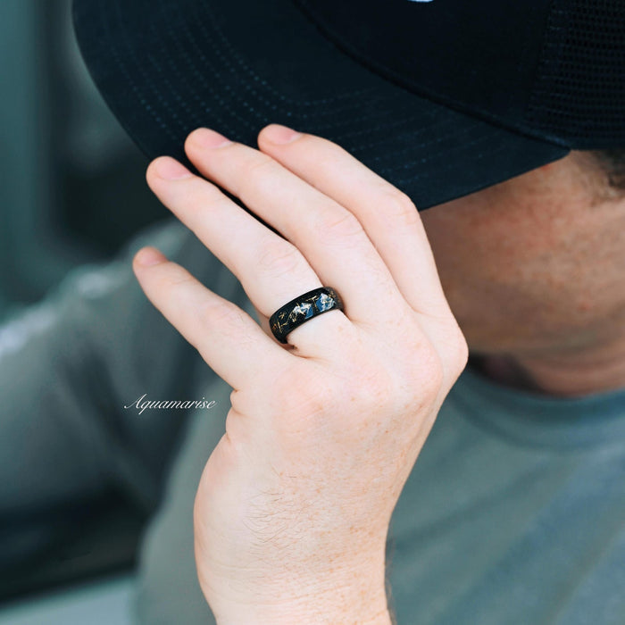 Stardust Couples Ring Set by Aquamarise featuring a black finish band with scattered gold and blue flecks, worn on a hand with a dark cap, part of Matching Couples' Rings, Best Selling Jewelry, and Black Finish Rings collections.