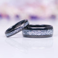 Starlux Simulated Crushed Diamond Couples Ring Set by Aquamarise featuring polished black tungsten carbide bands with a dazzling inlay of crushed silver stones, perfect for Matching Couples' Rings and April Birthstone Jewelry collections.