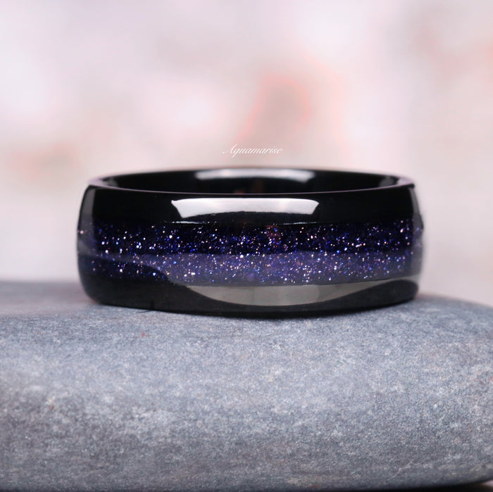 Starry Night Couples Ring Set featuring a gleaming black band with a sparkling galaxy-inspired blue sandstone inlay, crafted by Aquamarise for matching couples rings.