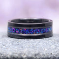 Starry Night & Blue Fire Opal Wedding Band- 8MM Black Tungsten featuring a striking crushed blue fire opal inlay set in a polished black tungsten band with silver edging, crafted by Aquamarise from Men’s Wedding Bands and October Birthstone collections.