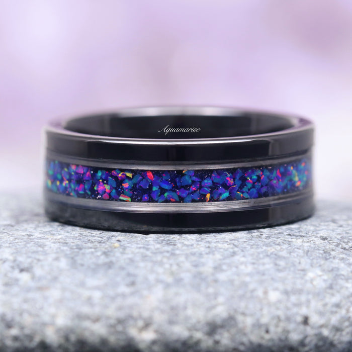 Starry Night & Blue Fire Opal Wedding Band- 8MM Black Tungsten featuring a striking crushed blue fire opal inlay set in a polished black tungsten band with silver edging, crafted by Aquamarise from Men’s Wedding Bands and October Birthstone collections.