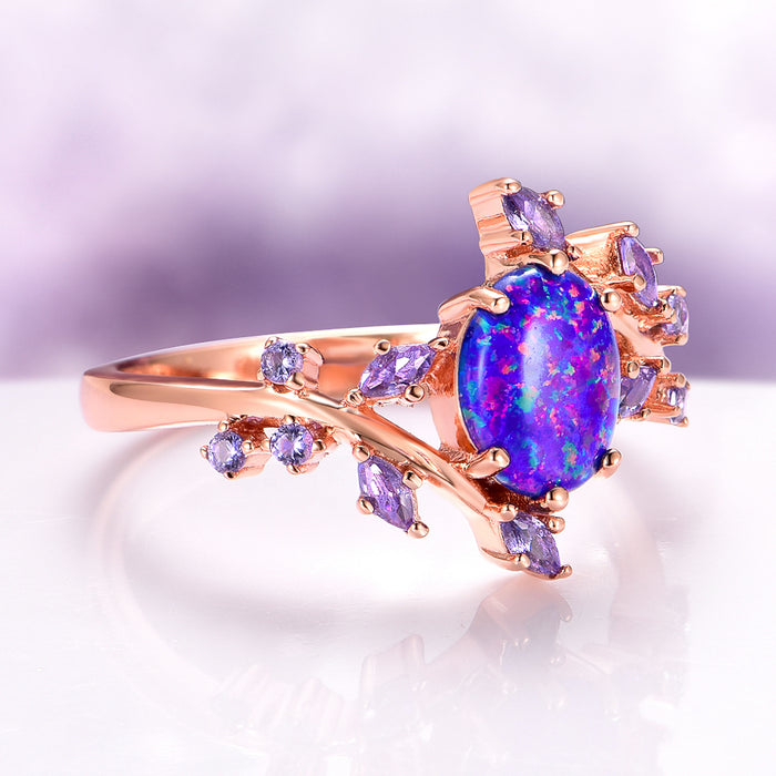 Starry Night Van Gogh Fire Opal & Rose Gold Leaf Couples Ring Set featuring a vibrant fire opal with swirling blue and purple hues, accented by marquise and round violet gemstones on a delicate rose gold band by Aquamarise.