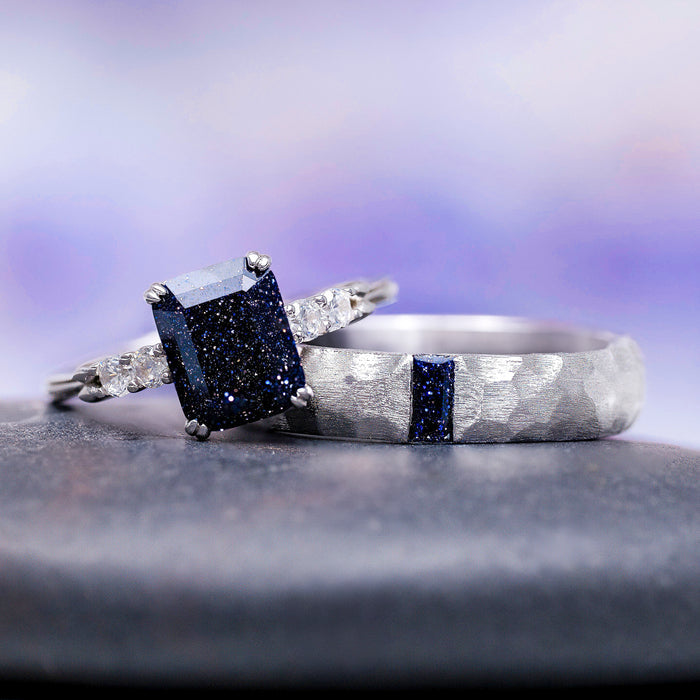 Starry Night Hammered Wedding Band in 14K White Gold (5.5mm) with hammered texture and dark blue gemstone accent, styled next to a sparkling rectangular-cut dark blue stone ring by Aquamarise Gold.