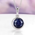 Starry Night Crescent Moon Necklace in Sterling Silver by Aquamarise, featuring a round faceted blue sandstone gemstone with sparkling flecks set in polished 925 sterling silver, part of collections including Necklaces and Birthstone Jewelry.